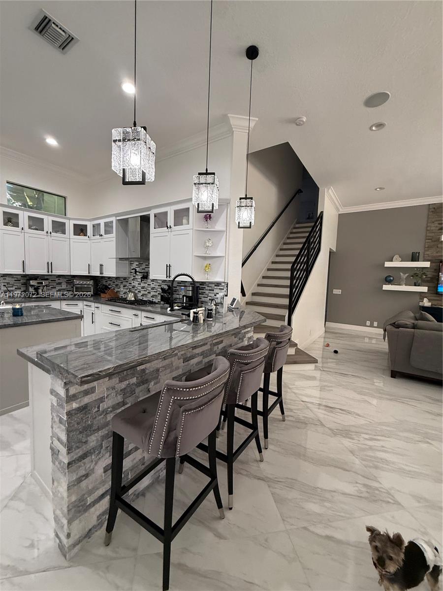 18610 Southwest 39th Court Miramar, FL 33029 - Photo 27 of 32 a large kitchen with a table and chairs in it