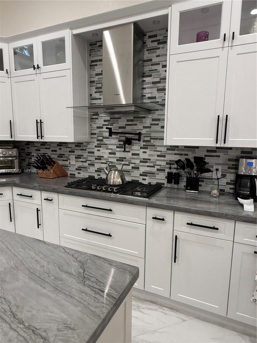 18610 Southwest 39th Court Miramar, FL 33029 - Photo 4 of 32 a kitchen with stainless steel appliances granite countertop a sink and a stove