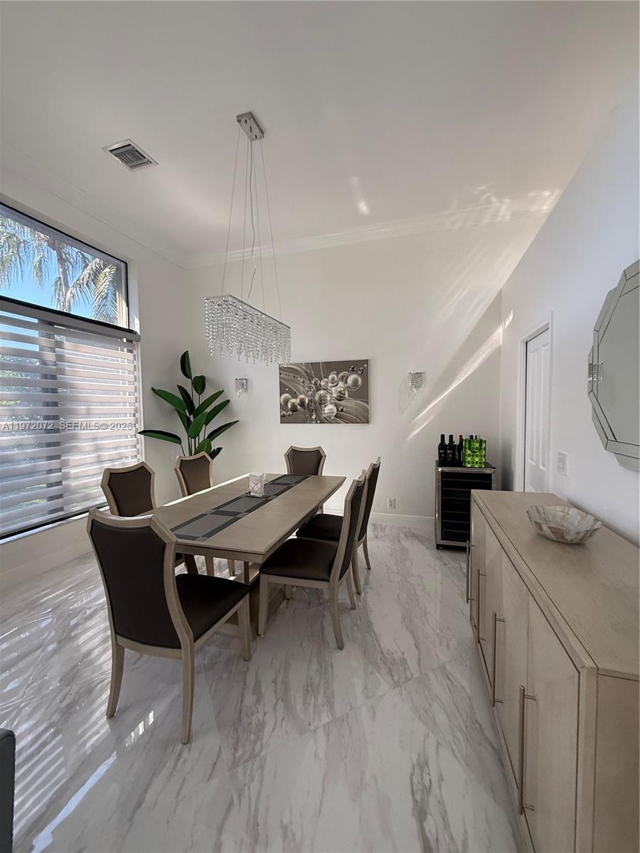 18610 Southwest 39th Court Miramar, FL 33029 - Photo 8 of 32 a dining room with furniture and wooden floor