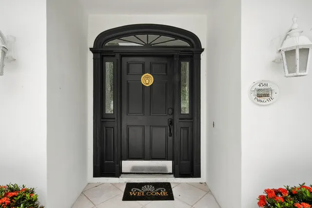 a kitchen with white cabinets and wooden floors