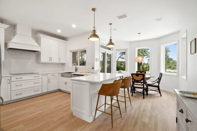 a kitchen with a refrigerator and a stove top oven