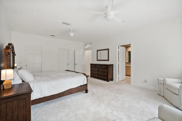 a bathroom with a shower sink vanity mirror and toilet