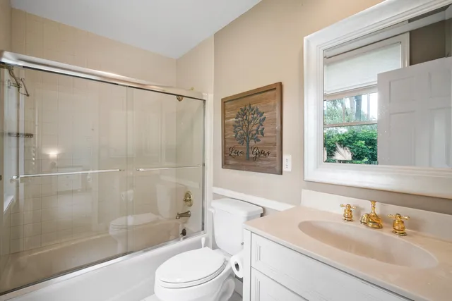 an aerial view of lake residential house with swimming pool and mountains