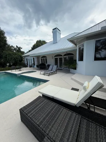 a view of house with outdoor space and sitting area