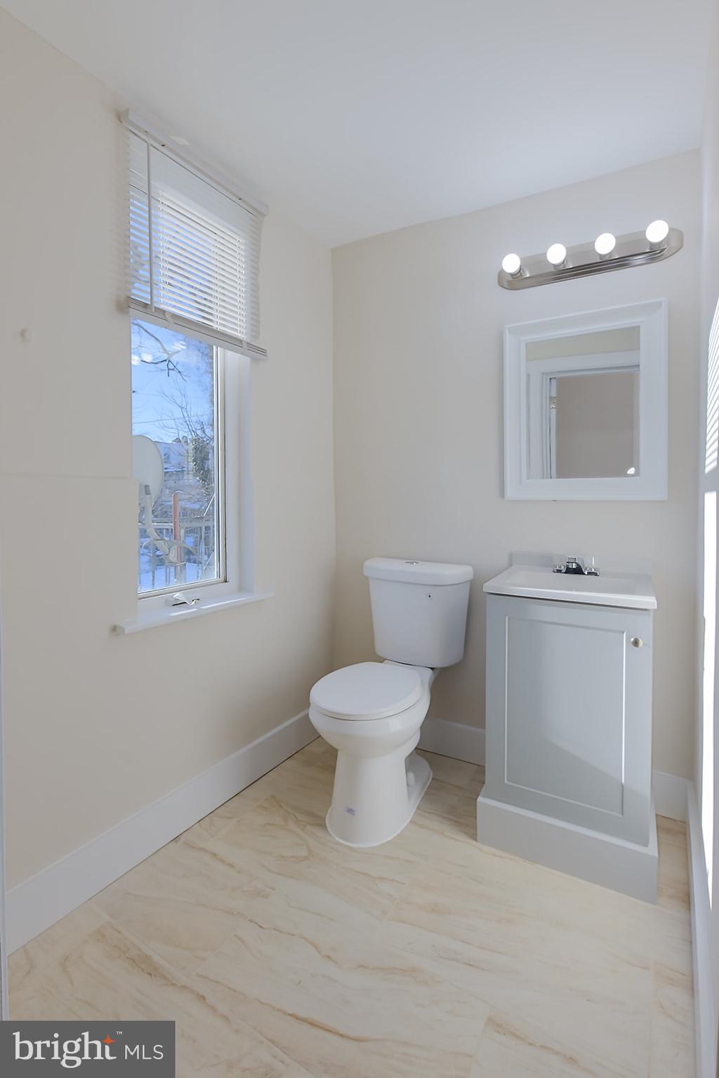 1908 McCulloh Street Baltimore, MD 21217 - Photo 12 of 40 a bathroom with a toilet sink and mirror