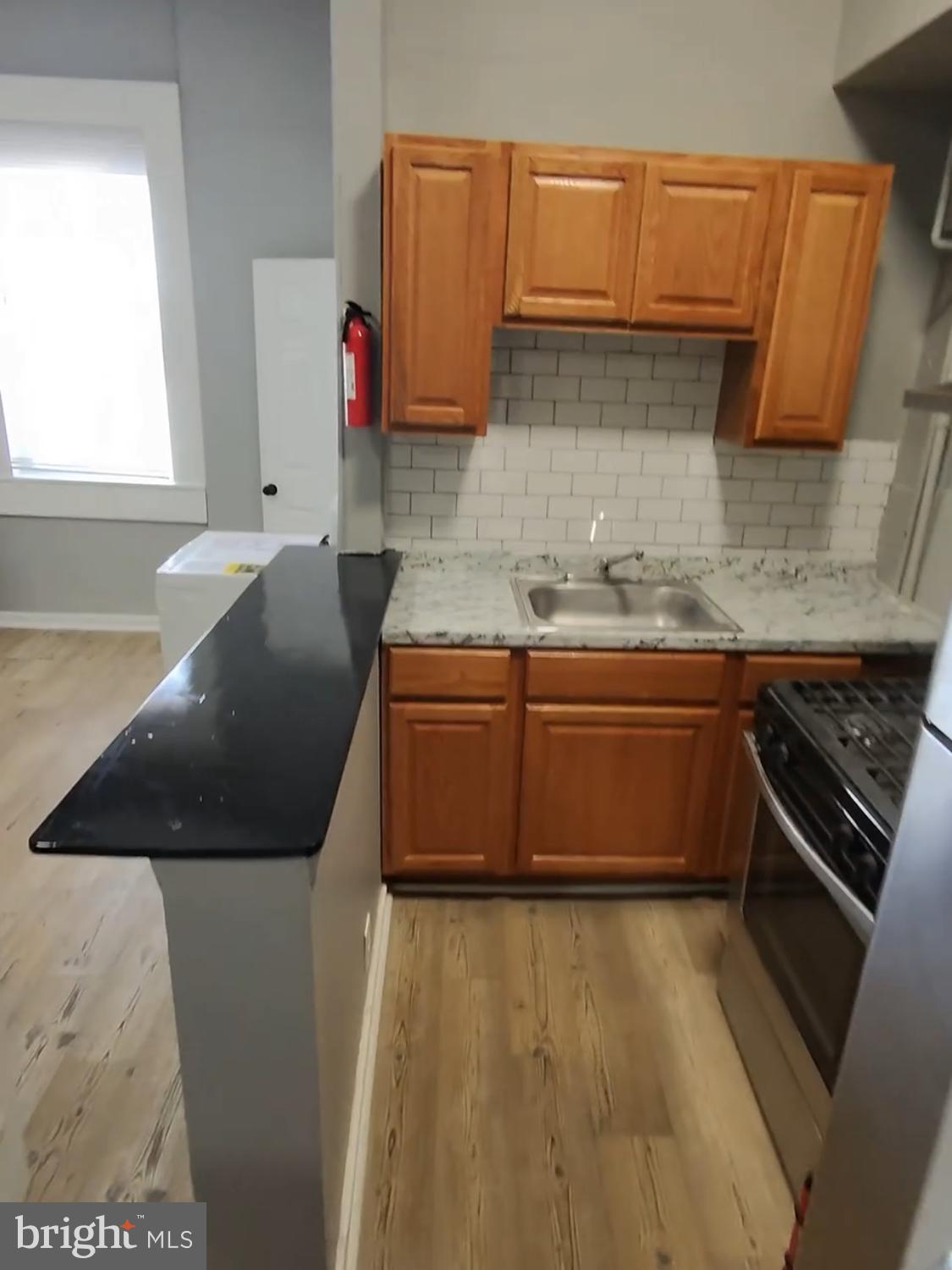 1908 McCulloh Street Baltimore, MD 21217 - Photo 15 of 40 a kitchen with a sink and a stove