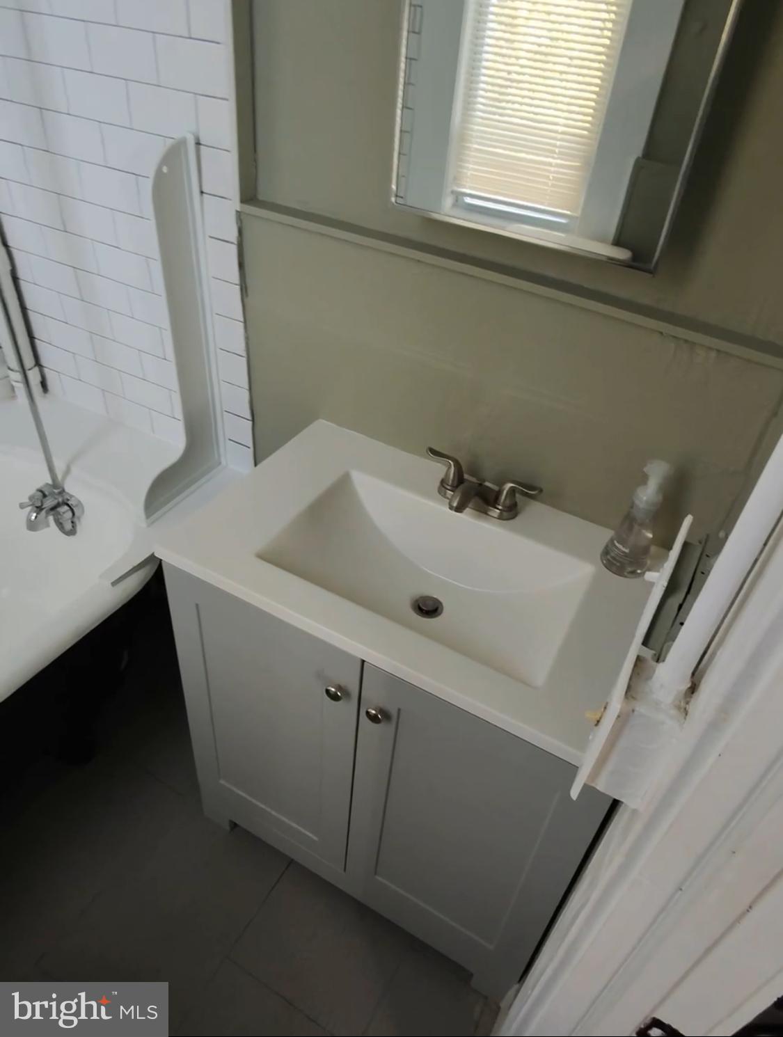1908 McCulloh Street Baltimore, MD 21217 - Photo 19 of 40 a bathroom with a sink and a mirror