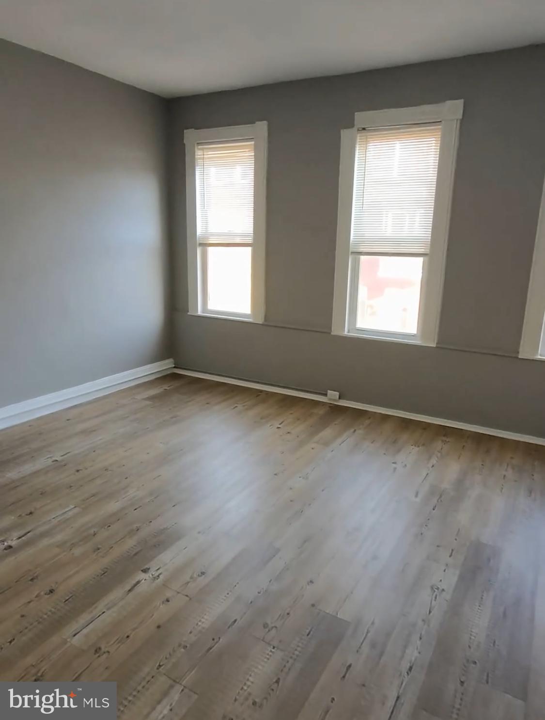 1908 McCulloh Street Baltimore, MD 21217 - Photo 22 of 40 an empty room with wooden floor and windows