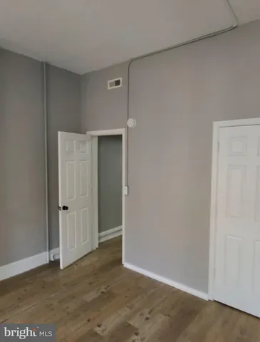 a kitchen with granite countertop a refrigerator and a sink