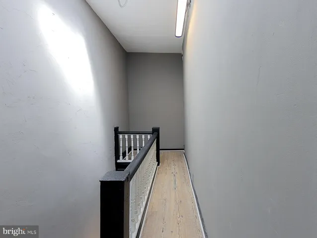 a view of kitchen with wooden floor electronic appliances and windows