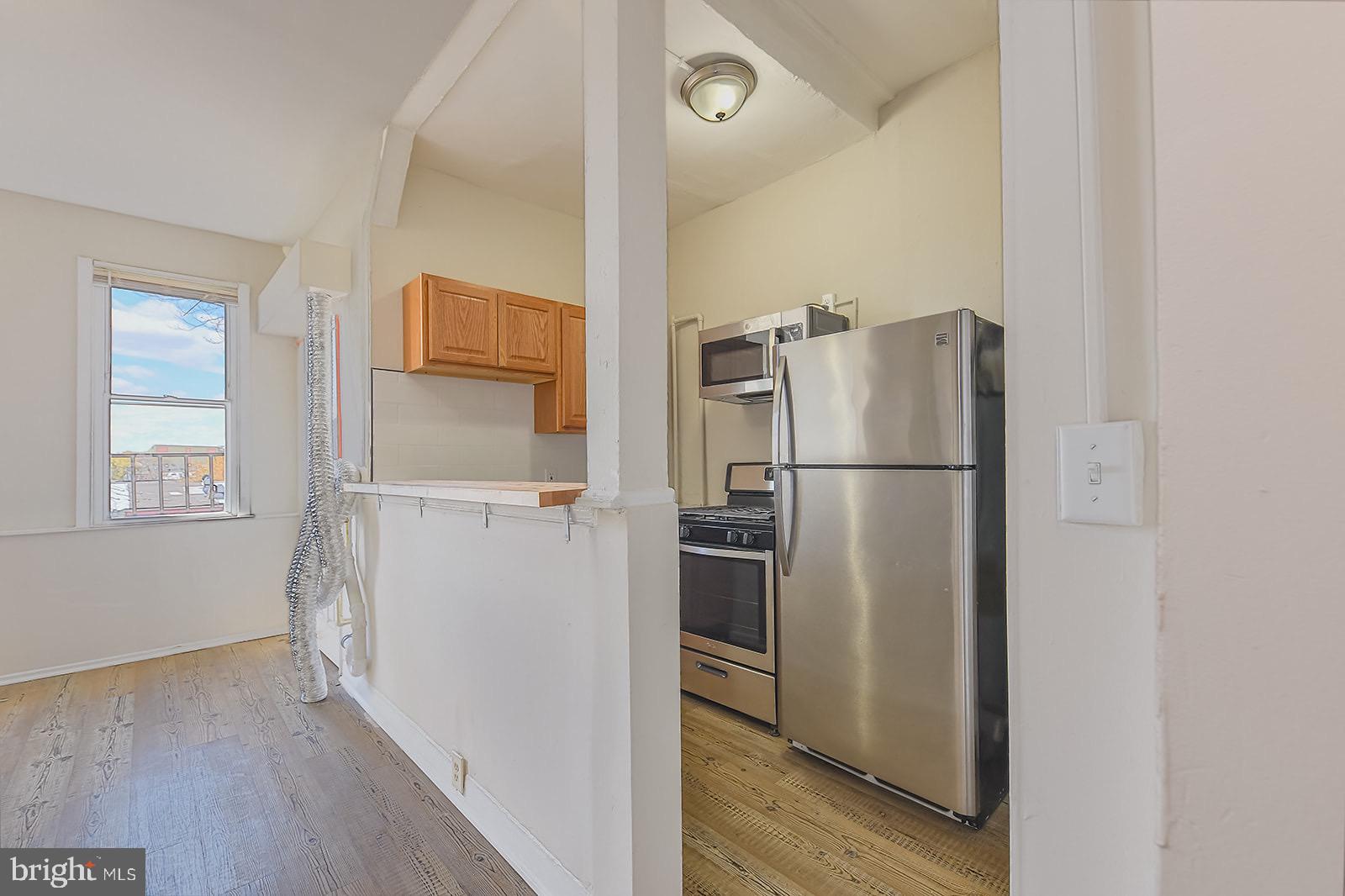1908 McCulloh Street Baltimore, MD 21217 - Photo 26 of 40 a view of kitchen with wooden floor electronic appliances and windows