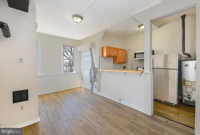 a view of a livingroom with wooden floor and stairs