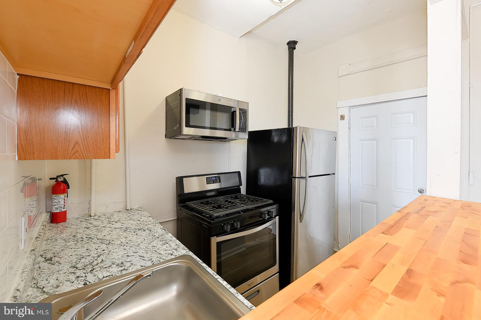 1908 McCulloh Street Baltimore, MD 21217 - Photo 34 of 40 a kitchen with a refrigerator and microwave