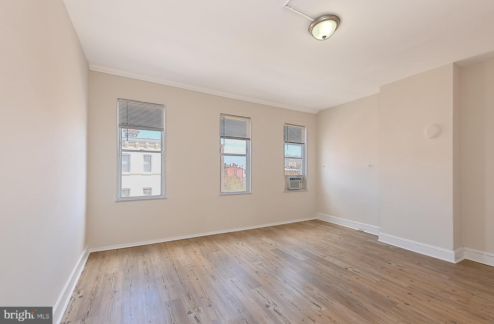 1908 McCulloh Street Baltimore, MD 21217 - Photo 39 of 40 an empty room with wooden floor and windows