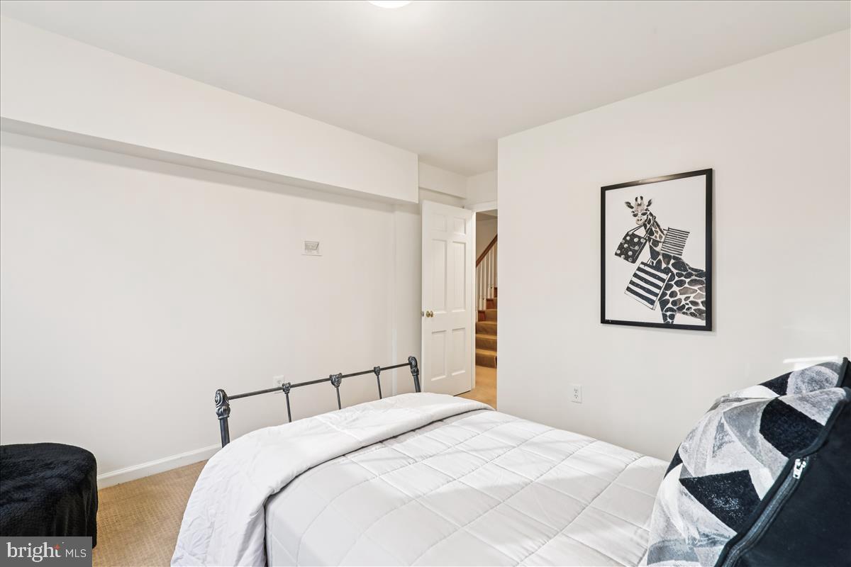 12145 Stirrup Road Reston, VA 20191 - Photo 22 of 80 a bedroom with a bed and a couch