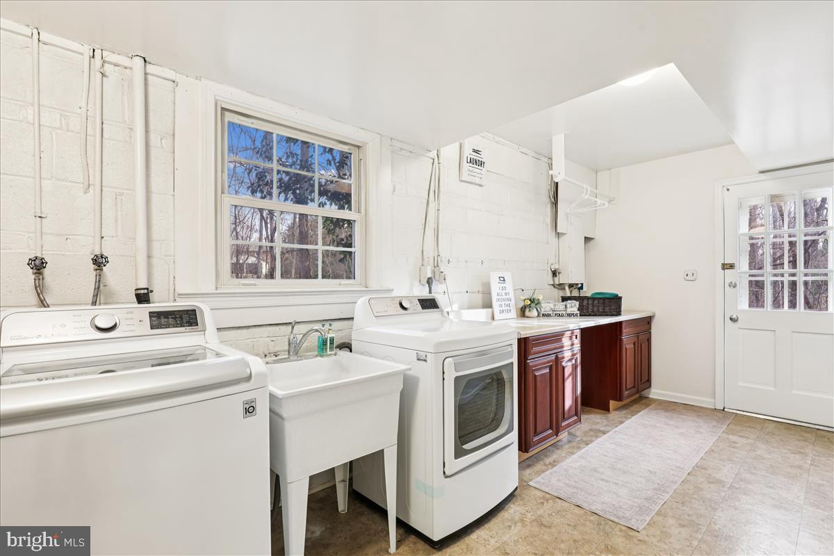 12145 Stirrup Road Reston, VA 20191 - Photo 26 of 80 a view of washer and dryer with kitchen in the background