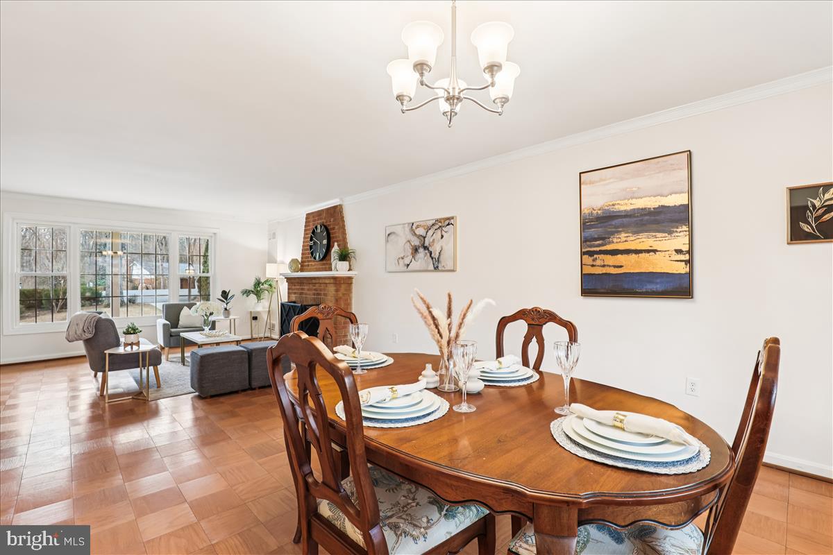 12145 Stirrup Road Reston, VA 20191 - Photo 38 of 80 a dining room with furniture a rug and a chandelier