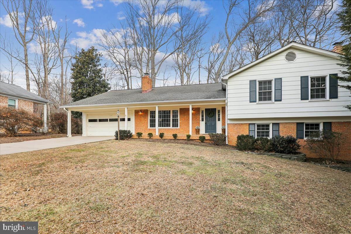 12145 Stirrup Road Reston, VA 20191 - Photo 4 of 80 a front view of a house with a garden