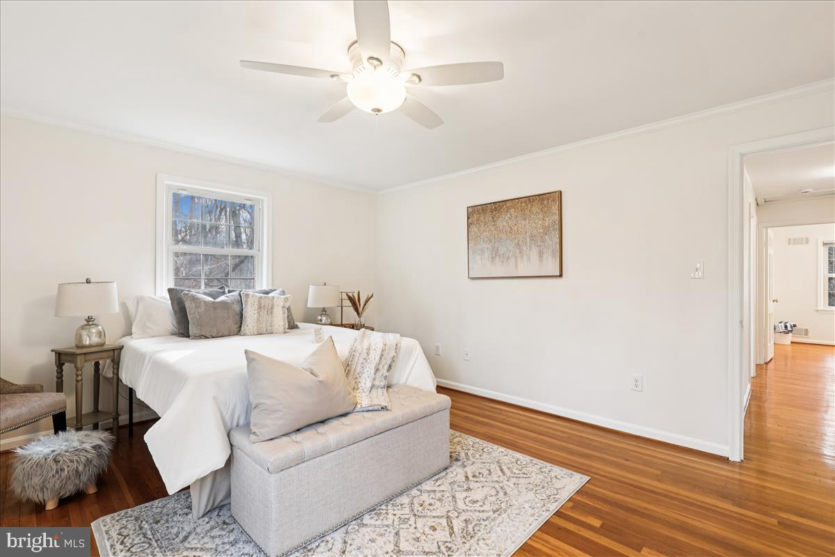 12145 Stirrup Road Reston, VA 20191 - Photo 58 of 80 a living room with a bed furniture chandelier and a window