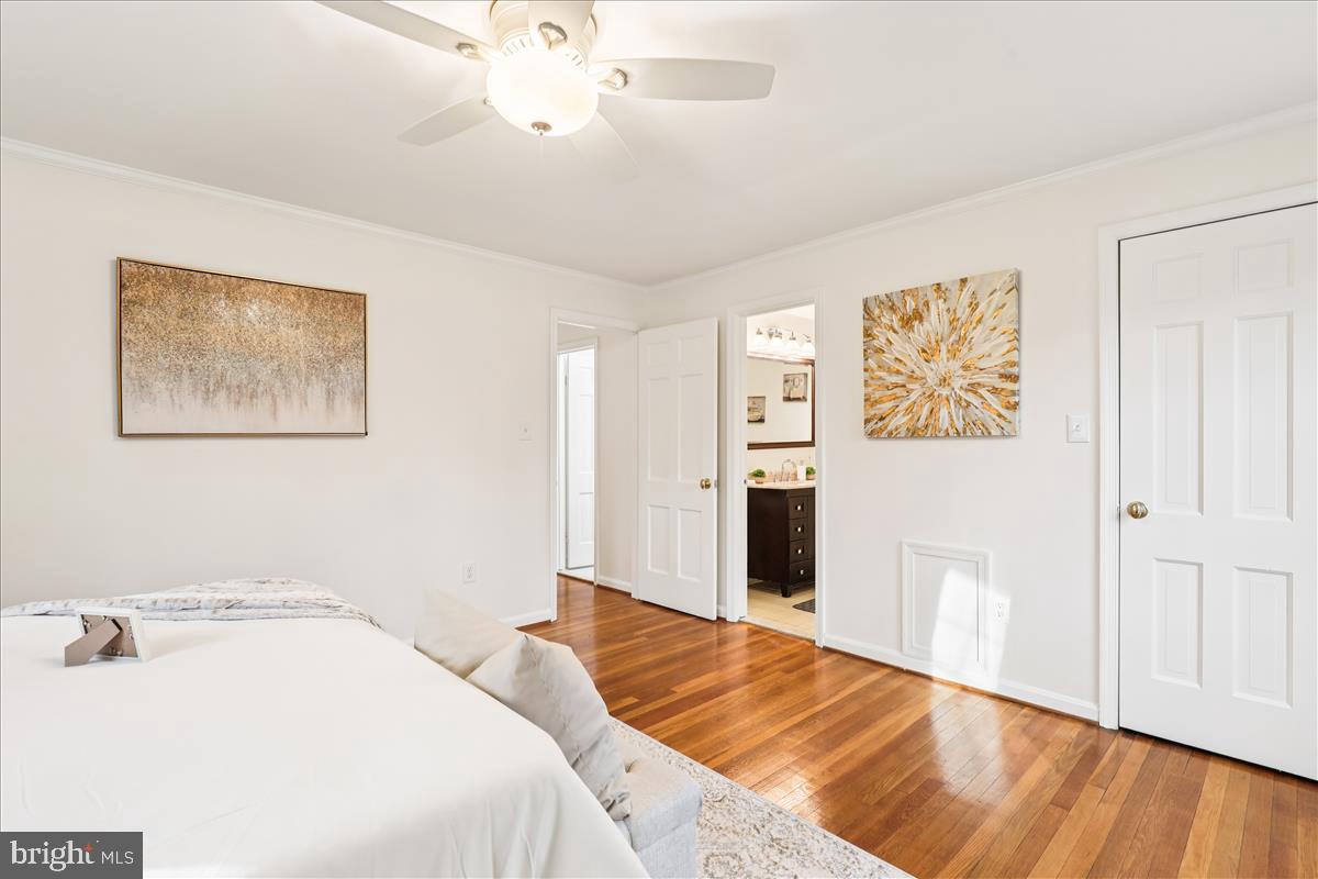 12145 Stirrup Road Reston, VA 20191 - Photo 61 of 80 a bedroom with a large bed and a chandelier