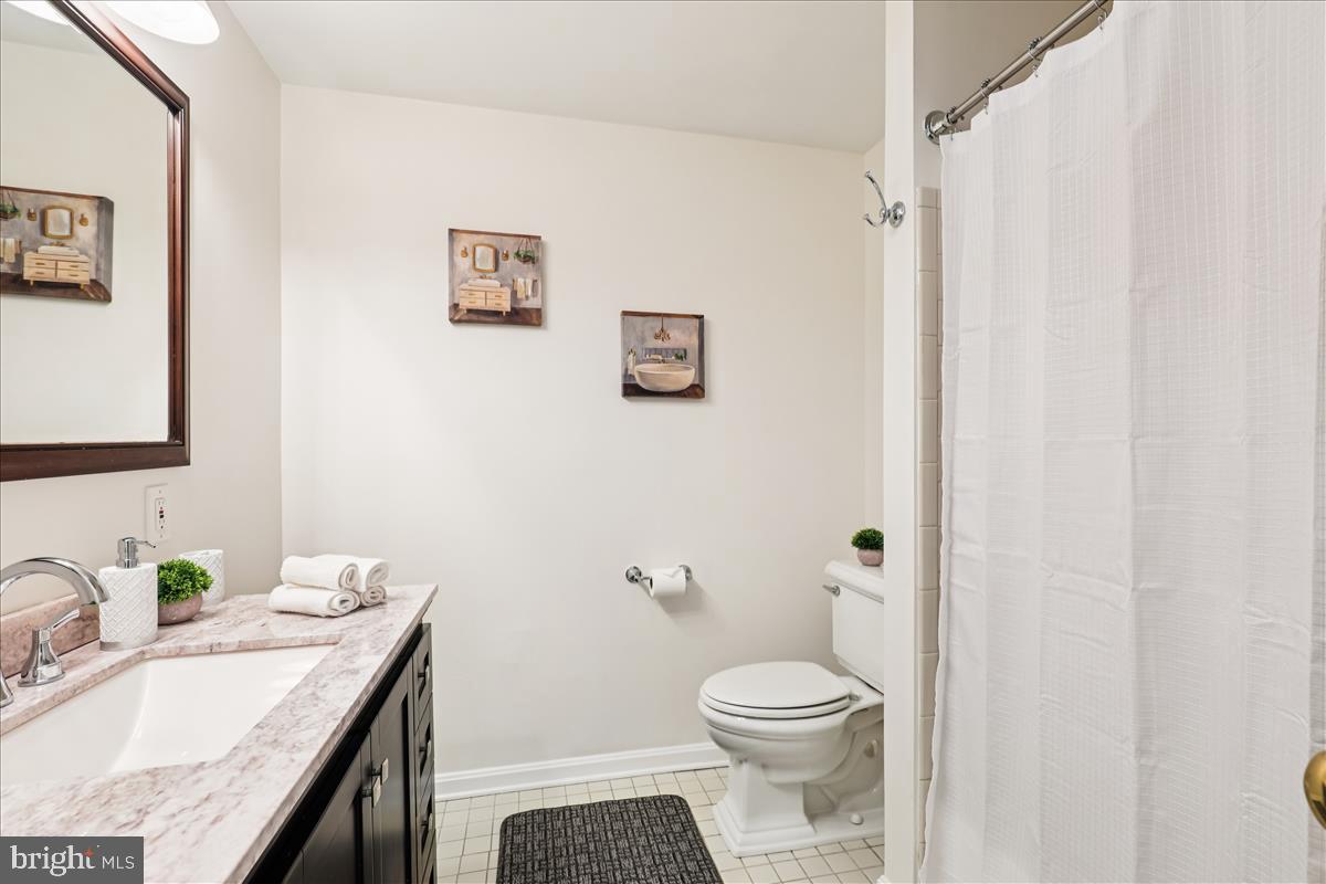 12145 Stirrup Road Reston, VA 20191 - Photo 62 of 80 a bathroom with a granite countertop sink a toilet and a mirror