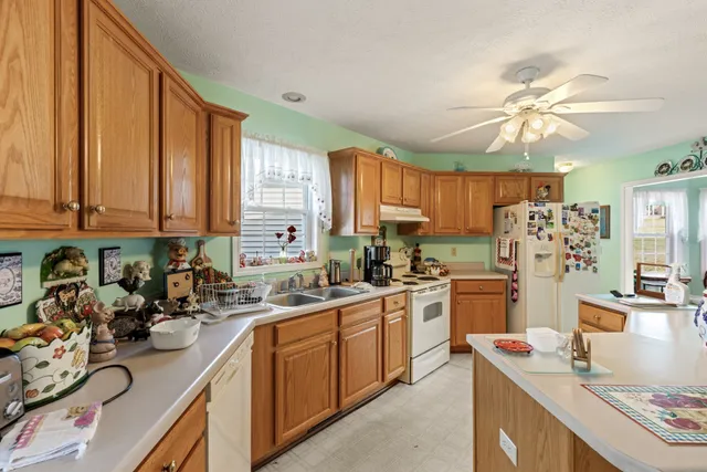 a kitchen with a sink stove and refrigerator