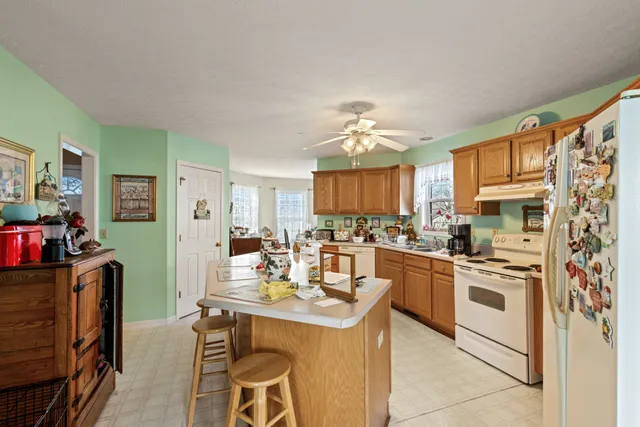 a kitchen with a stove a sink and a refrigerator