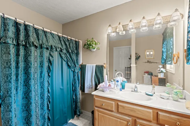 a bathroom with a double vanity sink and a mirror