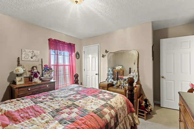 a bed room with a bed and a dresser