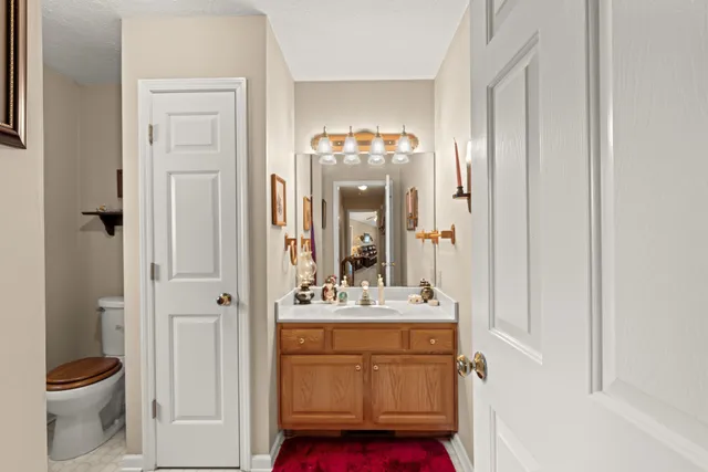 a bathroom with a sink vanity toilet and shower