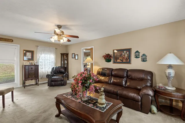 a living room with furniture and a chandelier