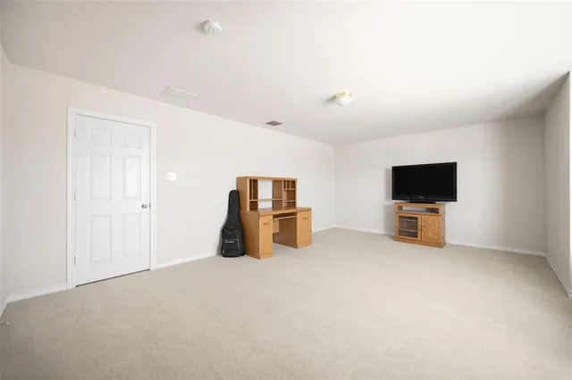 a view of a livingroom with furniture and a flat screen tv