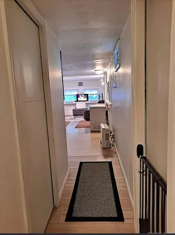 a view of a hallway with furniture