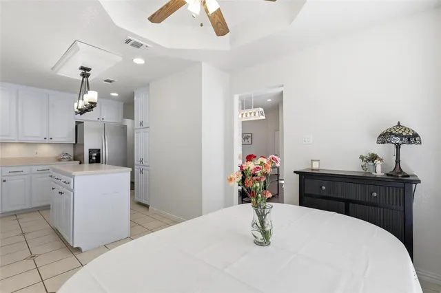 a room with a chandelier living and dining table