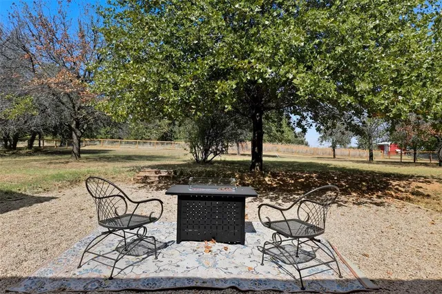 a backyard of a house with yard and tree