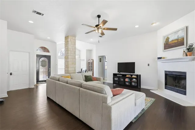 a living room with furniture a fireplace and a flat screen tv