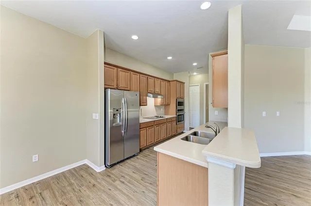 a kitchen with stainless steel appliances a refrigerator and a sink