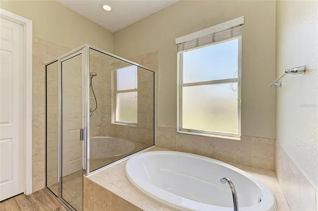 a bathroom with a tub and shower
