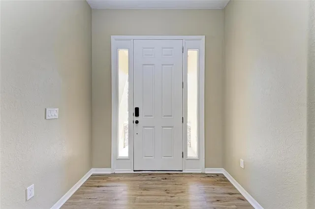 an empty room with wooden floor and closet