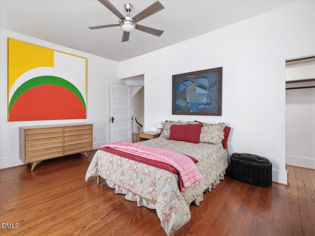215 Hillcrest Road Raleigh, NC 27605 - Photo 83 of 97 a bedroom with a bed and a painting on the wall