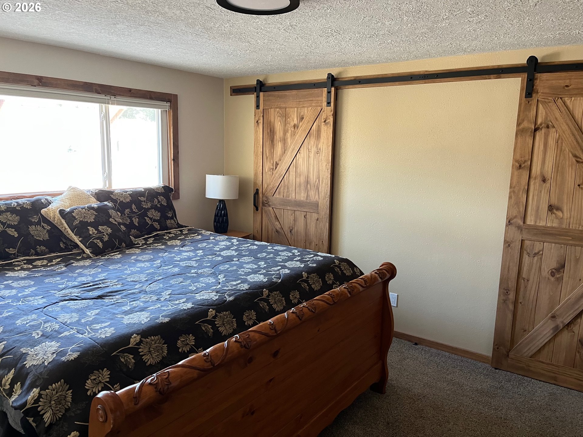 698 South Cascade Drive Woodburn, OR 97071 - Photo 12 of 19 a bedroom with a bed and a window