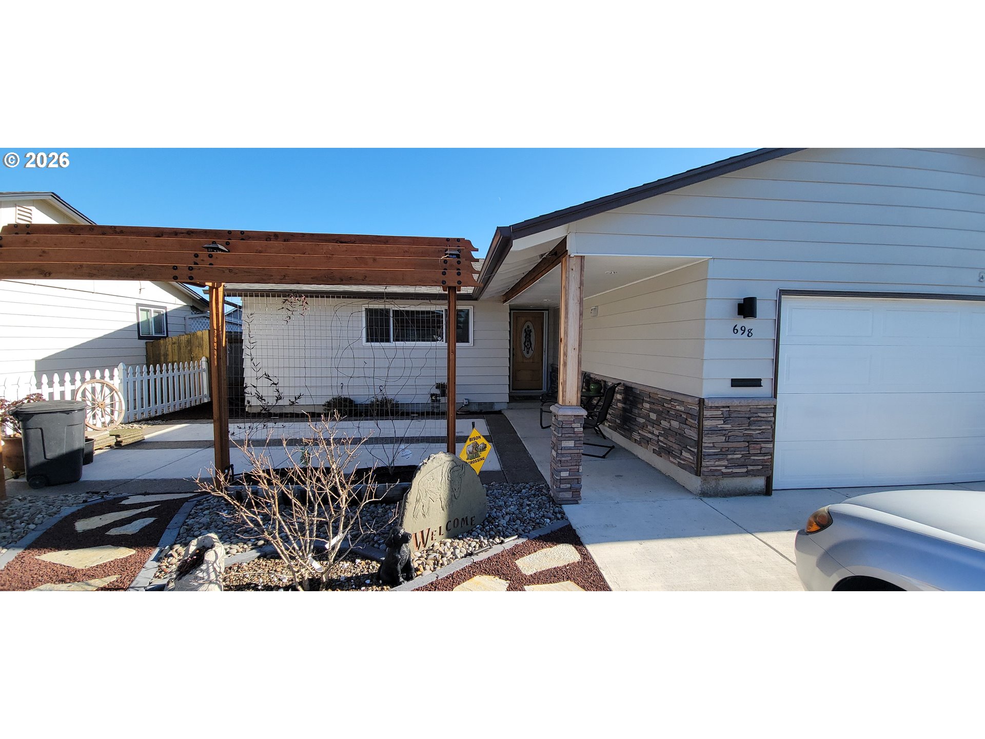 698 South Cascade Drive Woodburn, OR 97071 - Photo 2 of 19 a living room with furniture a rug and a wooden floor