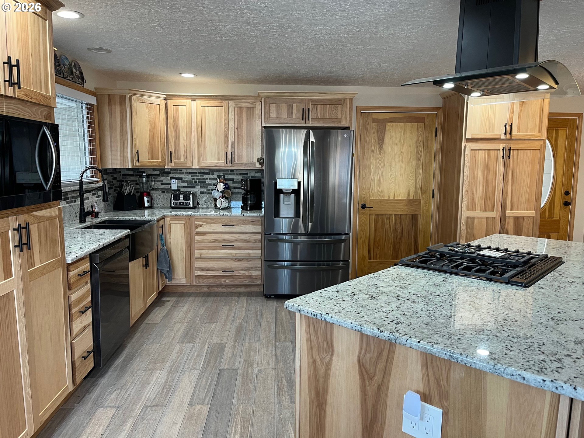 698 South Cascade Drive Woodburn, OR 97071 - Photo 5 of 19 a kitchen with a stove a refrigerator and a sink