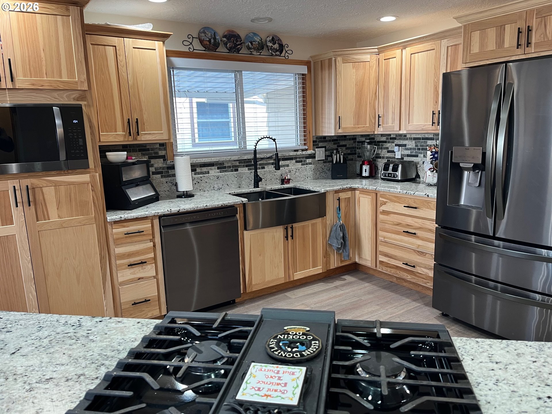698 South Cascade Drive Woodburn, OR 97071 - Photo 6 of 19 a kitchen with stainless steel appliances a stove a sink and a refrigerator
