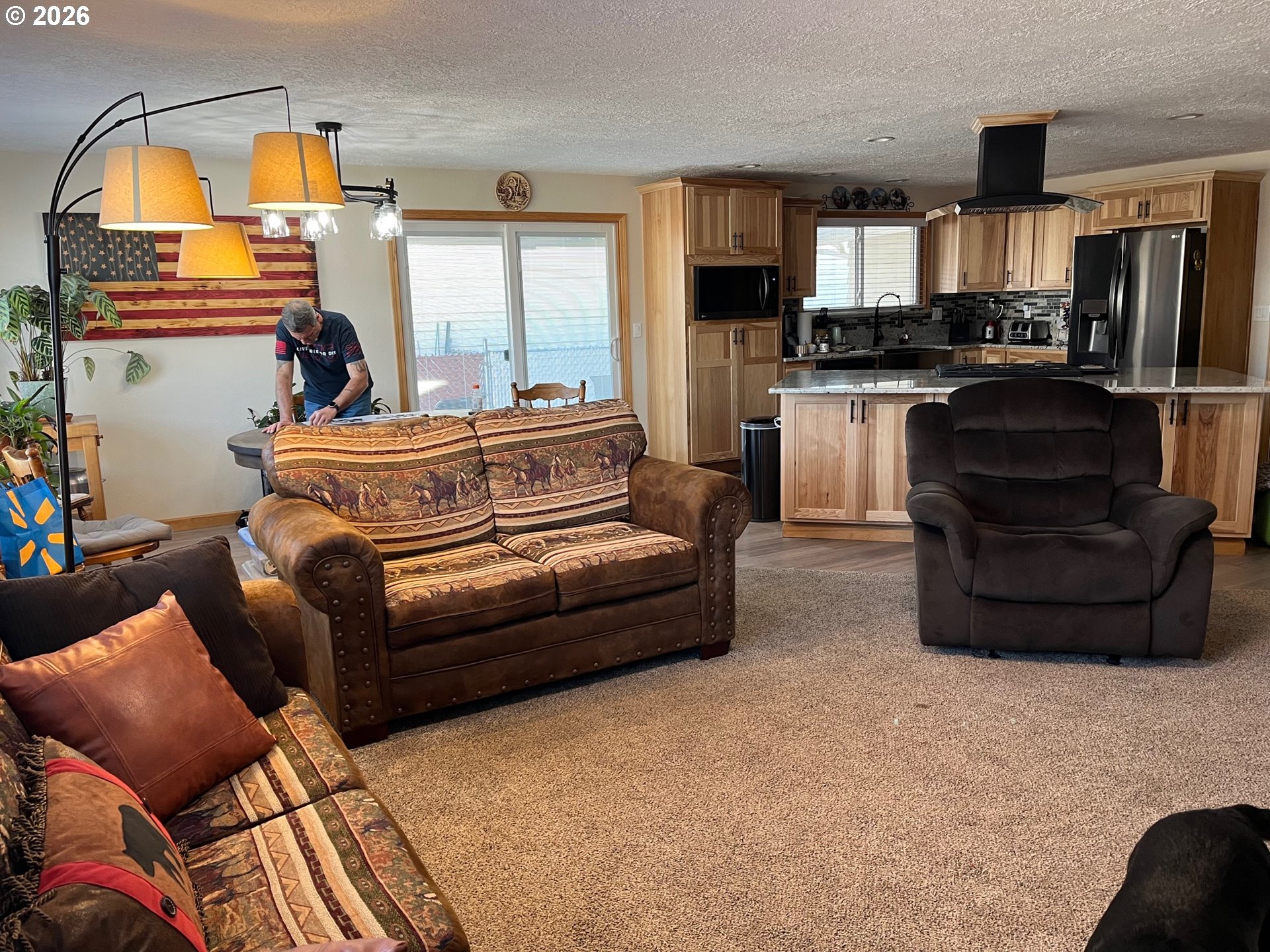 698 South Cascade Drive Woodburn, OR 97071 - Photo 8 of 19 a living room with furniture and a fireplace