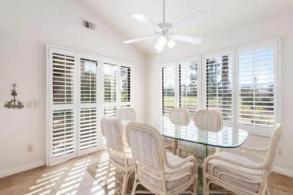 a dining room with furniture and windows