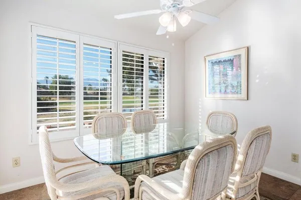 a view of a dining room with furniture and windows