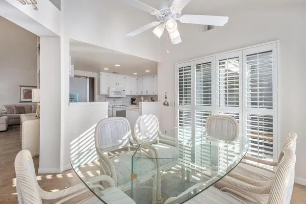 a dining room with furniture and a chandelier