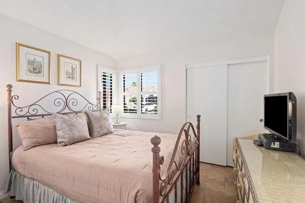 a bedroom with a bed and a flat screen tv