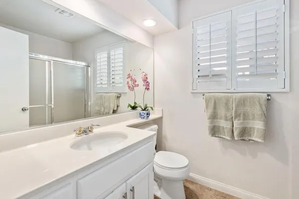 a bathroom with a sink toilet and a mirror